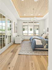 Primary Bedroom with access to exterior, a notable chandelier, light wood-type flooring, wood ceiling, and french doors