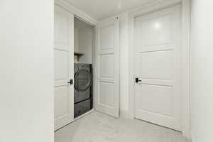 Lower Level Laundry area with light colored carpet and washer / dryer