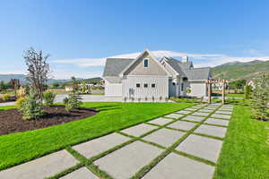 Exterior space with a mountain view, a pergola, a yard, and a patio