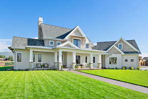 View of front facade with a porch and a front lawn