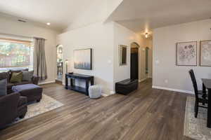 Living room featuring vaulted ceiling and hardwood / wood-style floors