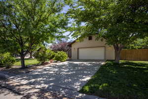 View of front of home featuring a garage and a front yard