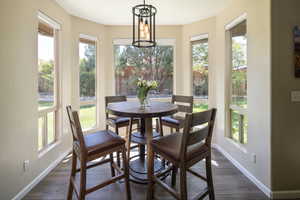 Dining area with dark hardwood / wood-style flooring and a chandelier