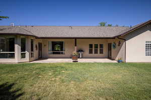 Back of house featuring a yard and a patio area