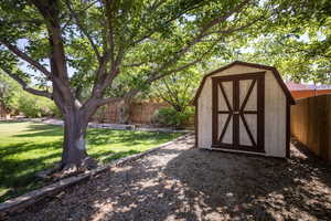 View of outdoor structure featuring a yard