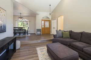 Living room featuring dark hardwood / wood-style floors and high vaulted ceiling