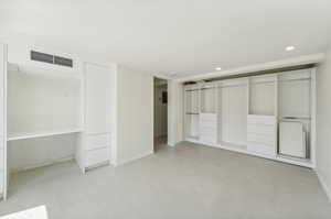 Unfurnished bedroom featuring a closet and light tile floors