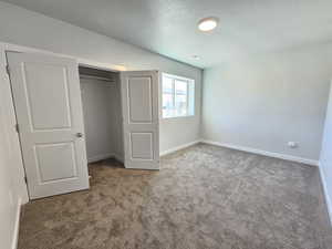 Unfurnished bedroom with a closet and carpet floors