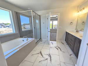 Bathroom featuring dual vanity, separate shower and tub, and tile floors