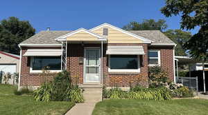 Bungalow-style house with a front yard