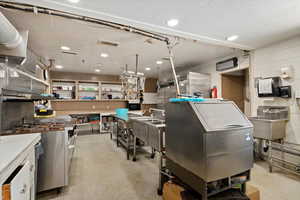 Commercial kitchen with newer industrial range. Other equipment and fire suppression.