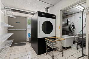 Commercial laundry with industrial washer, dryer and sanitation equipment.