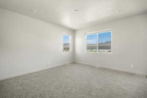 Unfurnished room featuring carpet floors and a textured ceiling