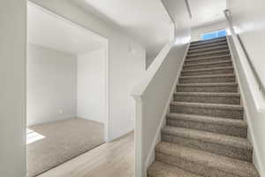 Stairs featuring light wood-type flooring