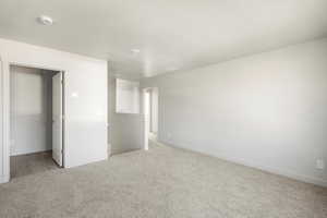 Unfurnished bedroom featuring carpet and a textured ceiling