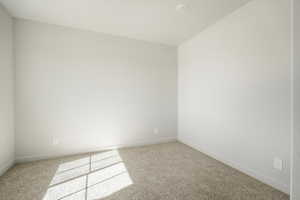 Unfurnished room featuring carpet flooring