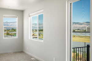 Empty room with carpet floors and a wealth of natural light