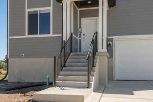 Doorway to property with a garage