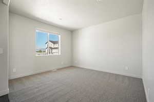 Empty room featuring carpet flooring