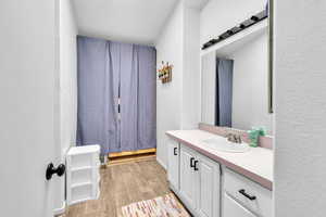 Bathroom featuring vanity and hardwood / wood-style floors