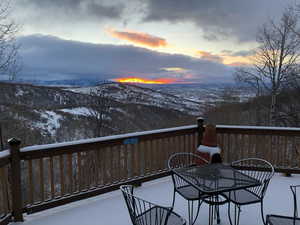 Snow covered deck featuring a mountain view