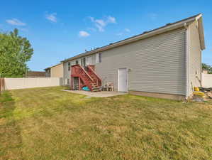 Rear view of property featuring a lawn