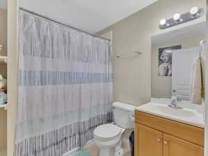 Bathroom featuring tile flooring, vanity, and toilet