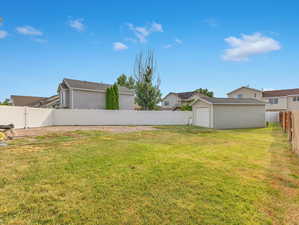 View of yard with an outdoor structure and a garage