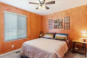 Carpeted bedroom with ceiling fan