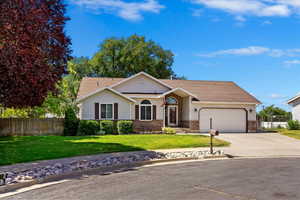 Ranch-style house with a front lawn and a garage