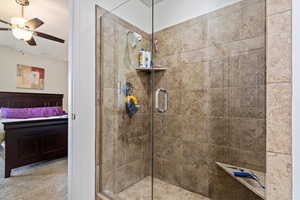 Bathroom with ceiling fan and an enclosed shower