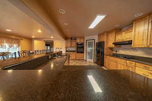 Open kitchen area with large L shape bar perfect for all your entertaining.