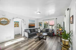 Living room with wood-type flooring