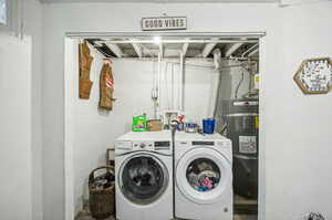 Laundry room with hookup for a washing machine, separate washer and dryer, and secured water heater