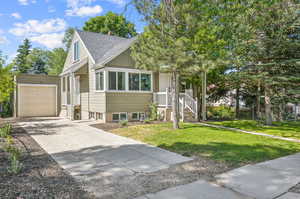 View of front of house featuring a garage and a front lawn