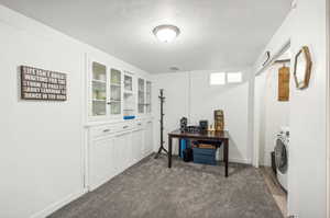 Family room with carpet floors and washer / dryer