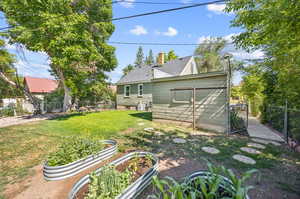 Rear view of house with a yard