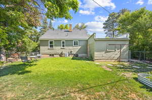 Back of house featuring a yard; back view of one car garage