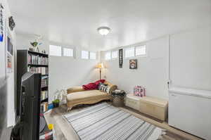 Bedroom or family room featuring wood-type flooring with outside entrance