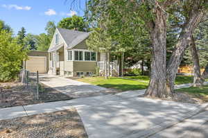 View of front of house with a front lawn and one car  garage