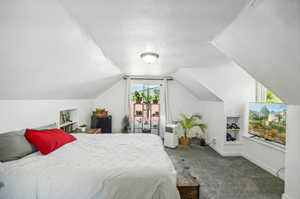 Carpeted bedroom with vaulted ceiling