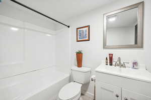 Full bathroom featuring shower / bathing tub combination, toilet, and large vanity