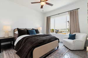 Carpeted bedroom featuring ceiling fan