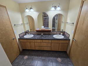 Bathroom with tile floors and dual bowl vanity