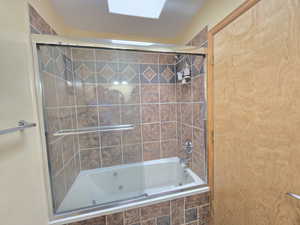 Bathroom featuring enclosed tub / shower combo