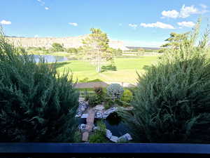 View of home's community featuring a lawn and a water view