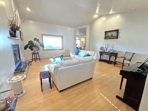 Living room featuring light hardwood / wood-style flooring and vaulted ceiling