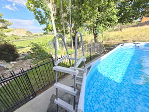 View of pool featuring a lawn