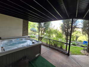 View of patio with a hot tub