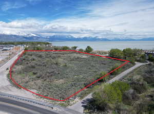 Birds eye view of property with a water and mountain view